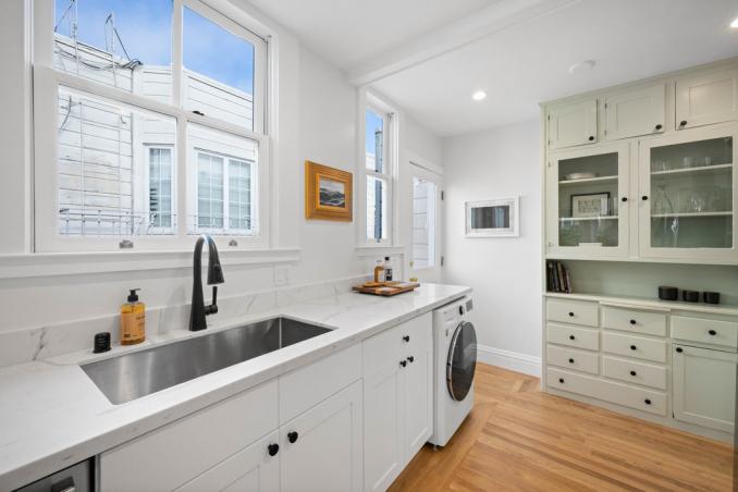 Property Thumbnail: Deep stainless sink, stone counters, washer/dryer combo under countertop. 
