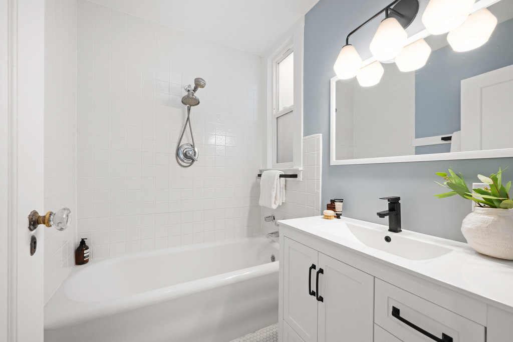 Property Photo: Bathroom has tub and new vanity. 