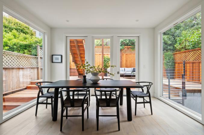 Property Thumbnail: The dining room is engulfed by floor to ceiling windows and has french doors that open up to outdoor space.