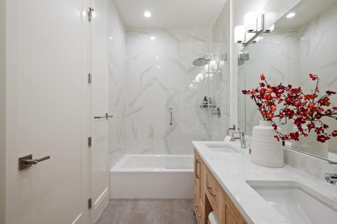 Property Thumbnail: Primary bathroom. White walls, bath tiles and double vanity. 
