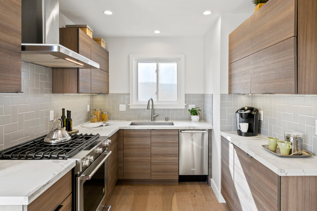 View of the kitchen, showing modern wood cabinets and high-end appliances