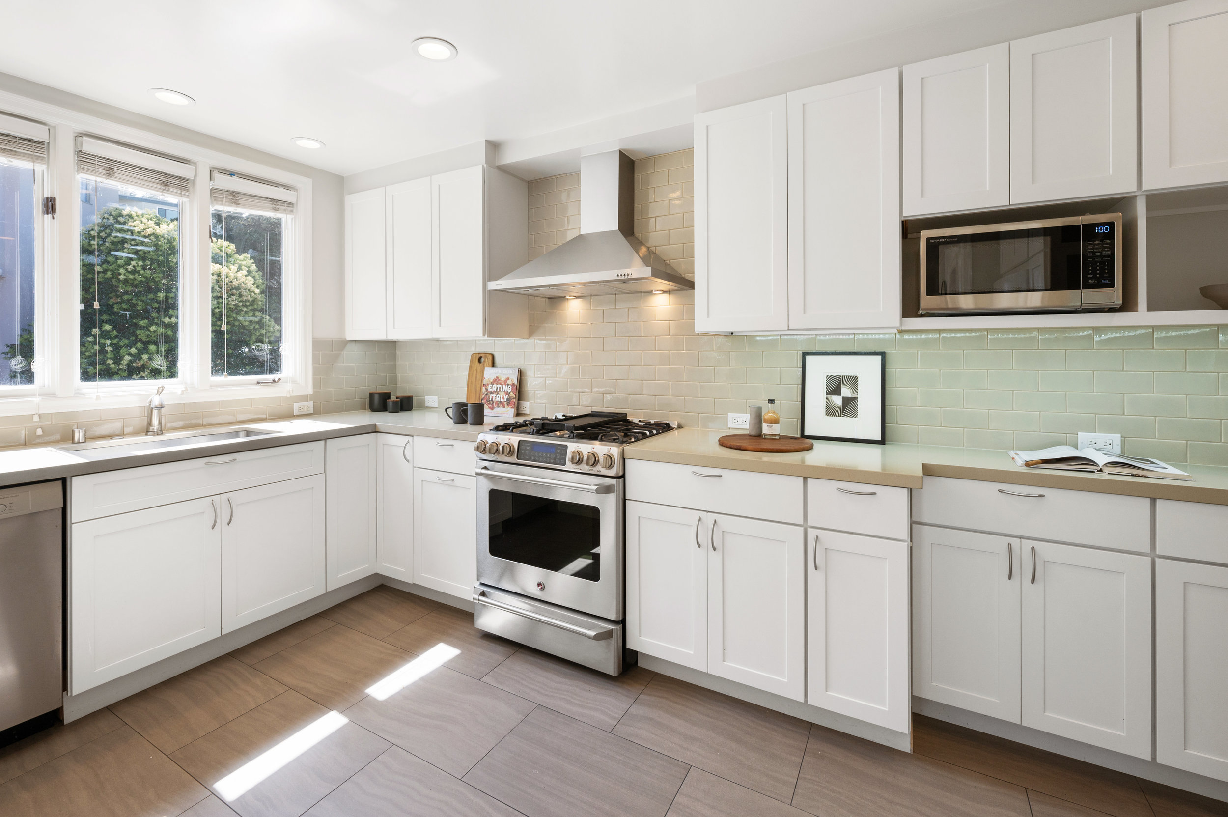 View of the chefs kitchen featuring Ann Sacks tile backsplash