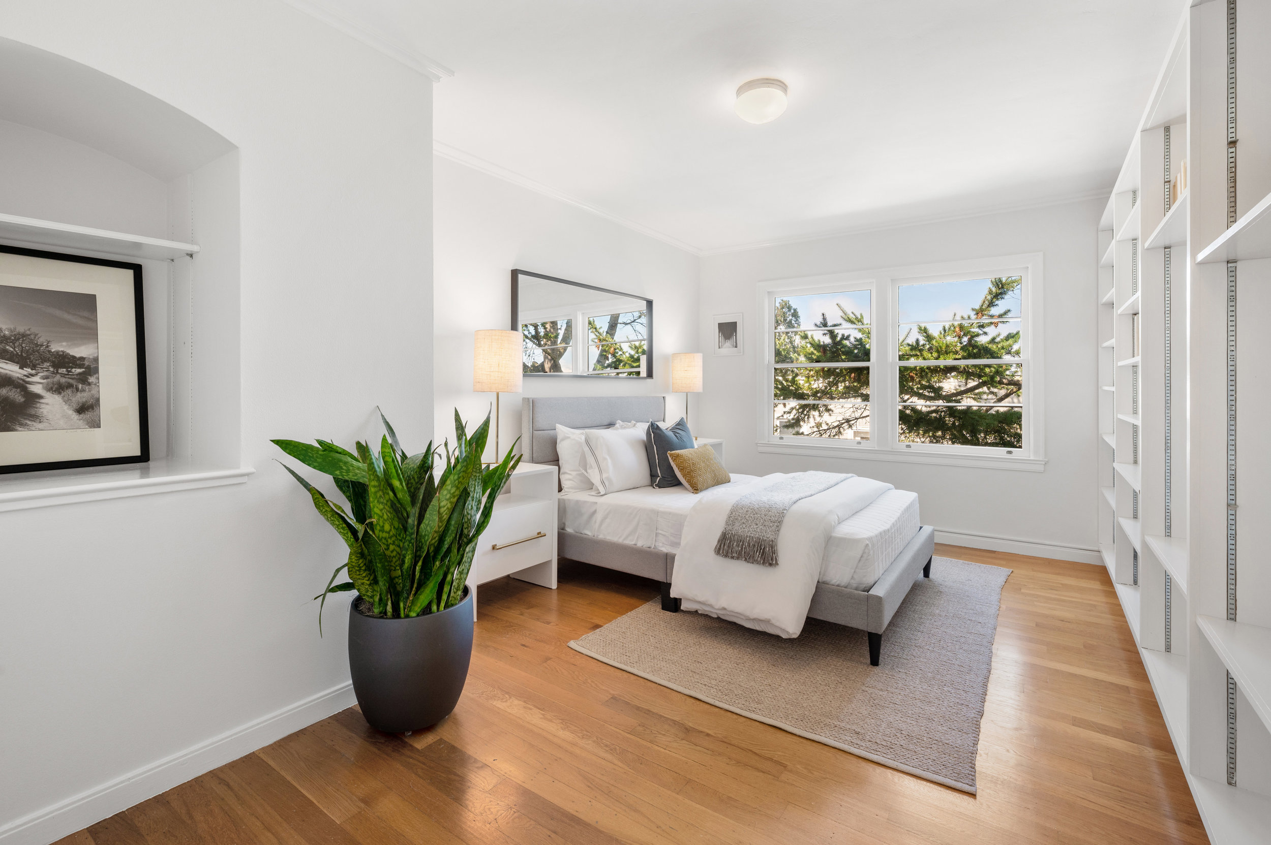 Bedroom three featuring custom shelving and large windows