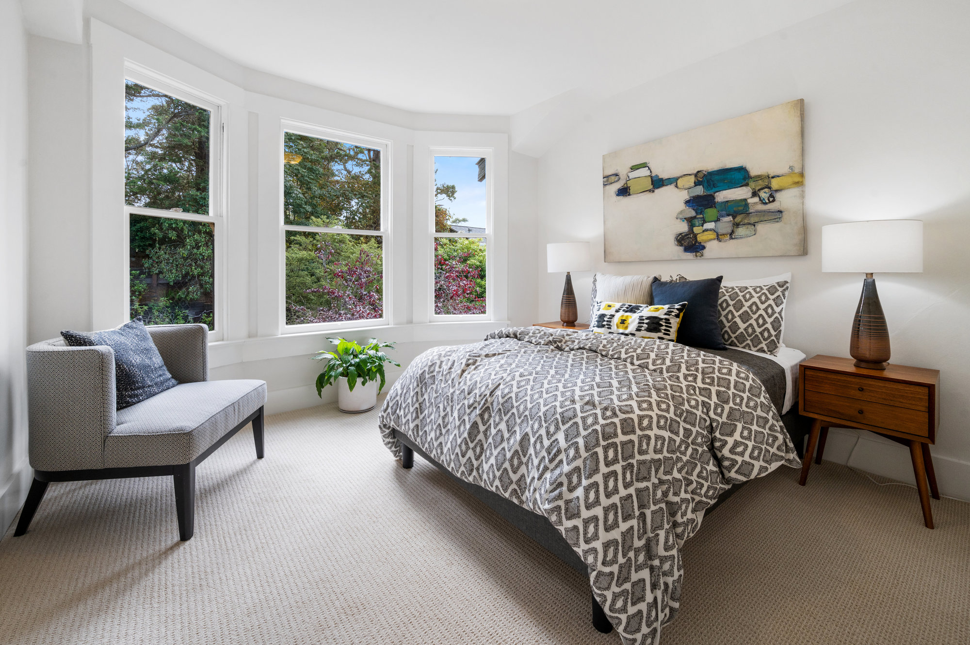 View of a large bedroom with bay windows