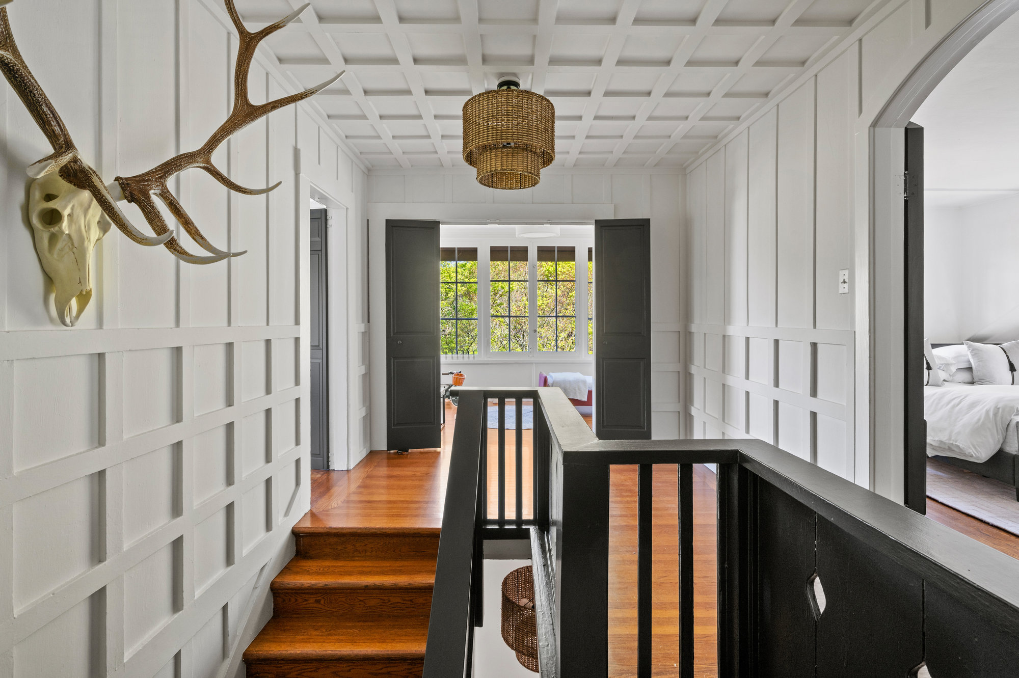 View of the upper hall featuring beautiful woodwork