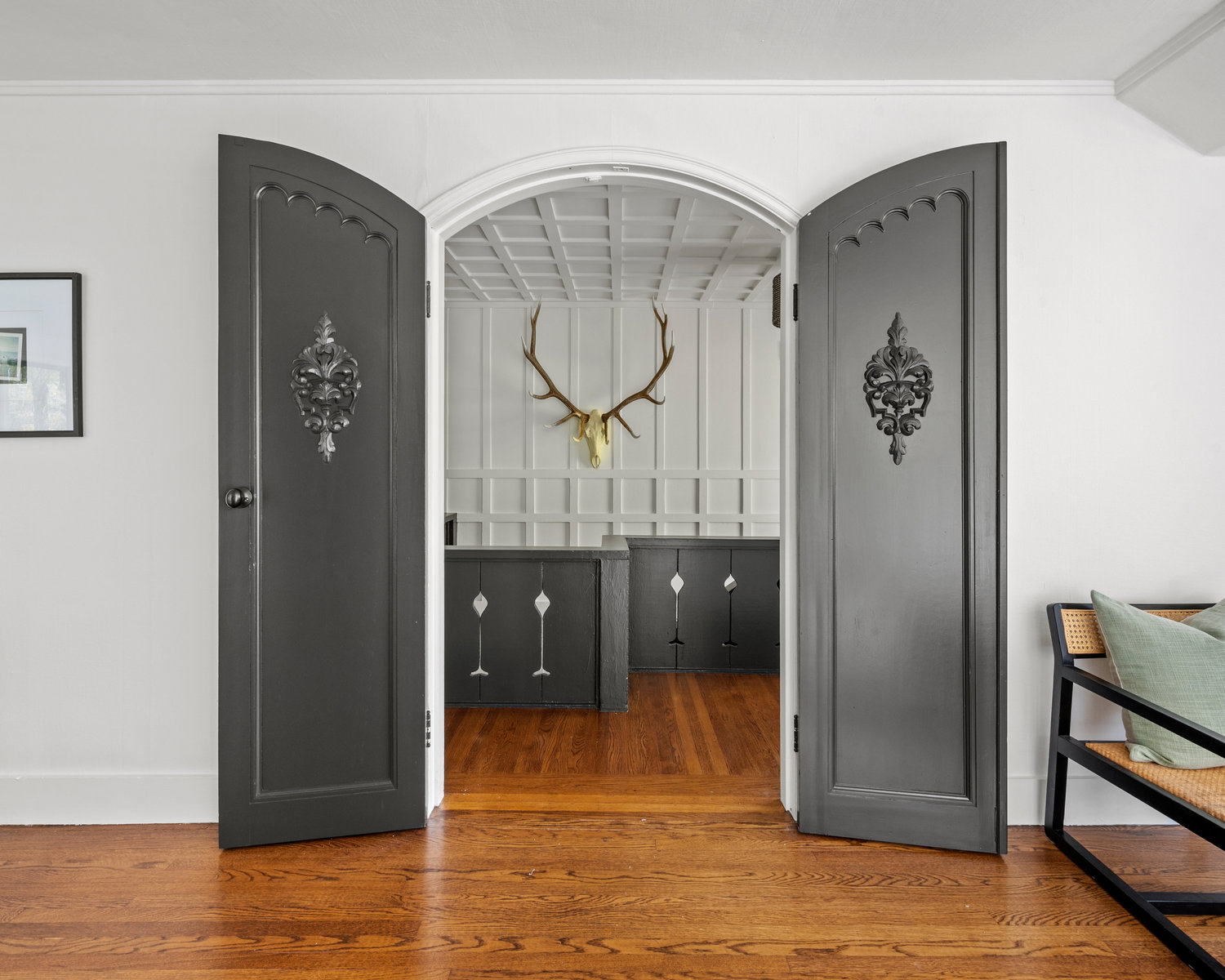 View of the primary bedroom door with ornate carving