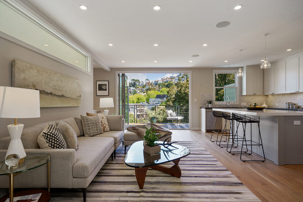 Open doors lead out to the deck of 118 Woodland Ave in San Francisco