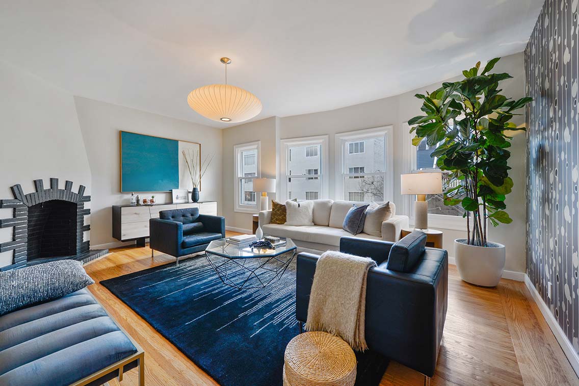 The crisp white art deco living room of 228 Liberty 