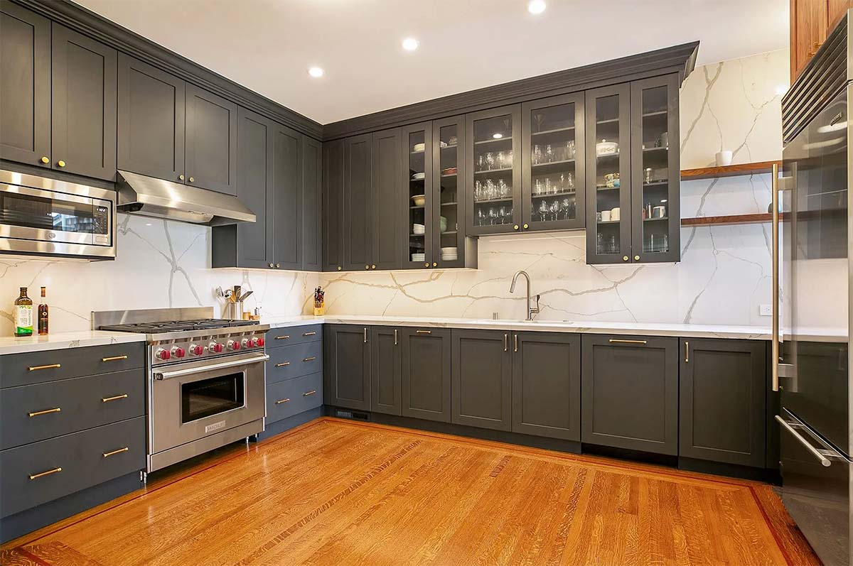 View of the kitchen post remodel, showing modern grey cabinetry 
