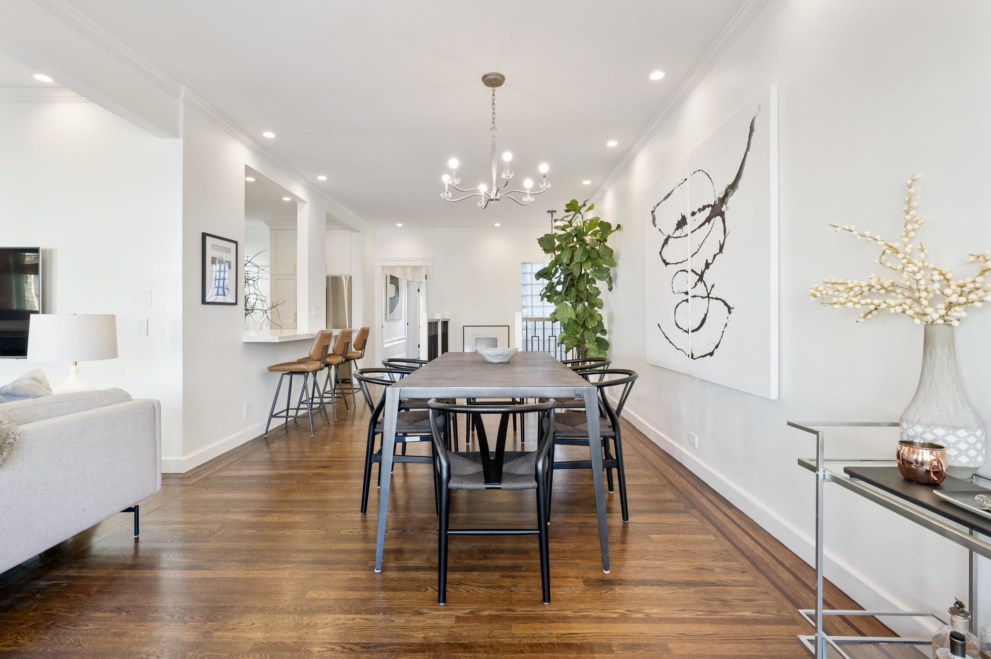 Long view of the dining area, featuring wood floors 