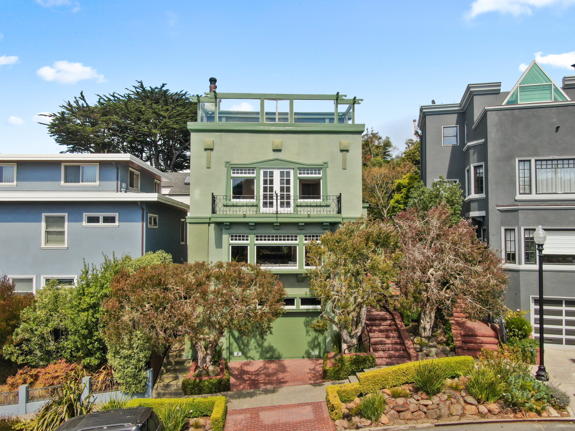 Front exterior view of 4 Ashbury Terrace, showing a large three story Craftsman style home