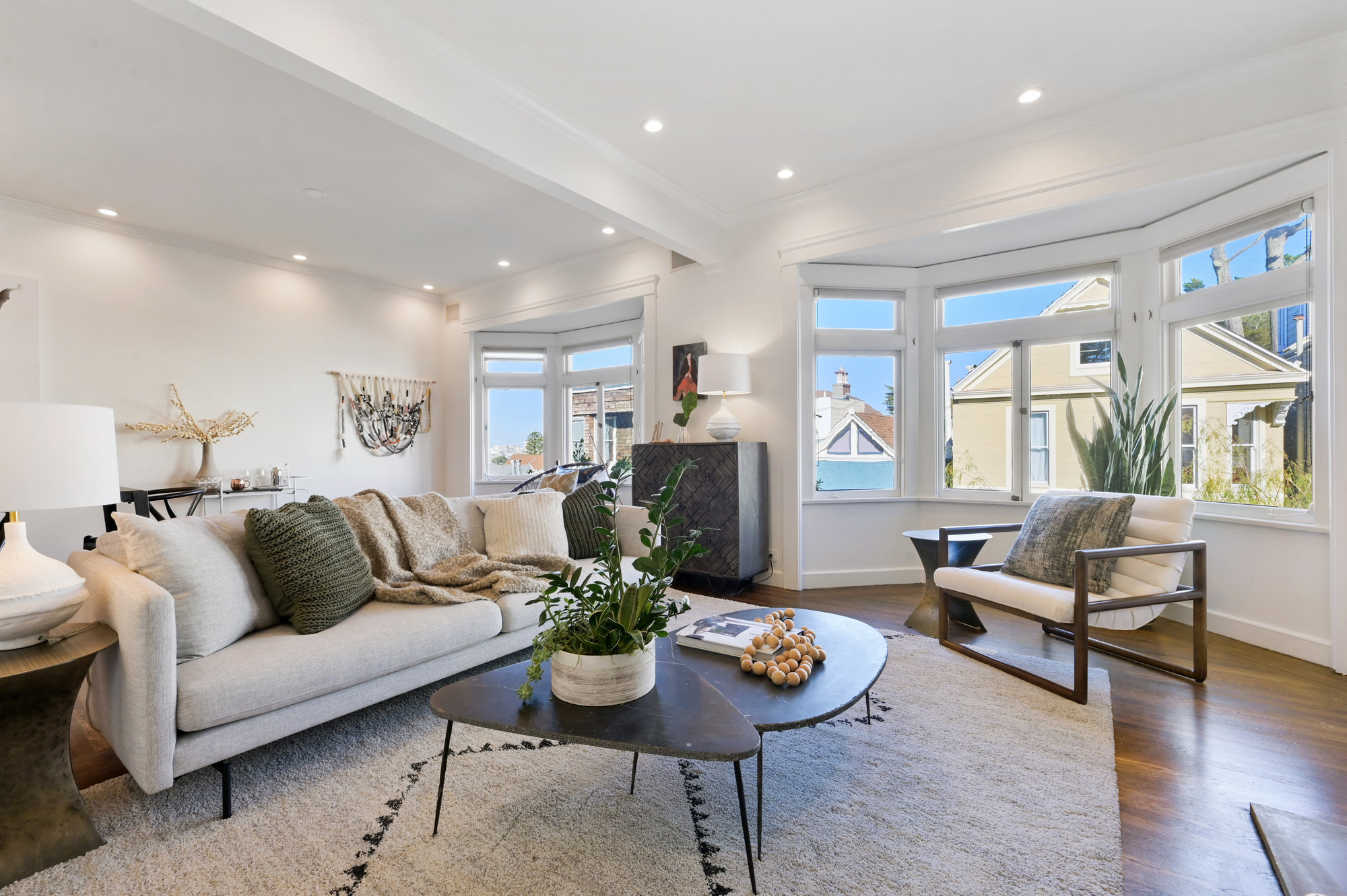 Living room, featuring wood floors and two bay window