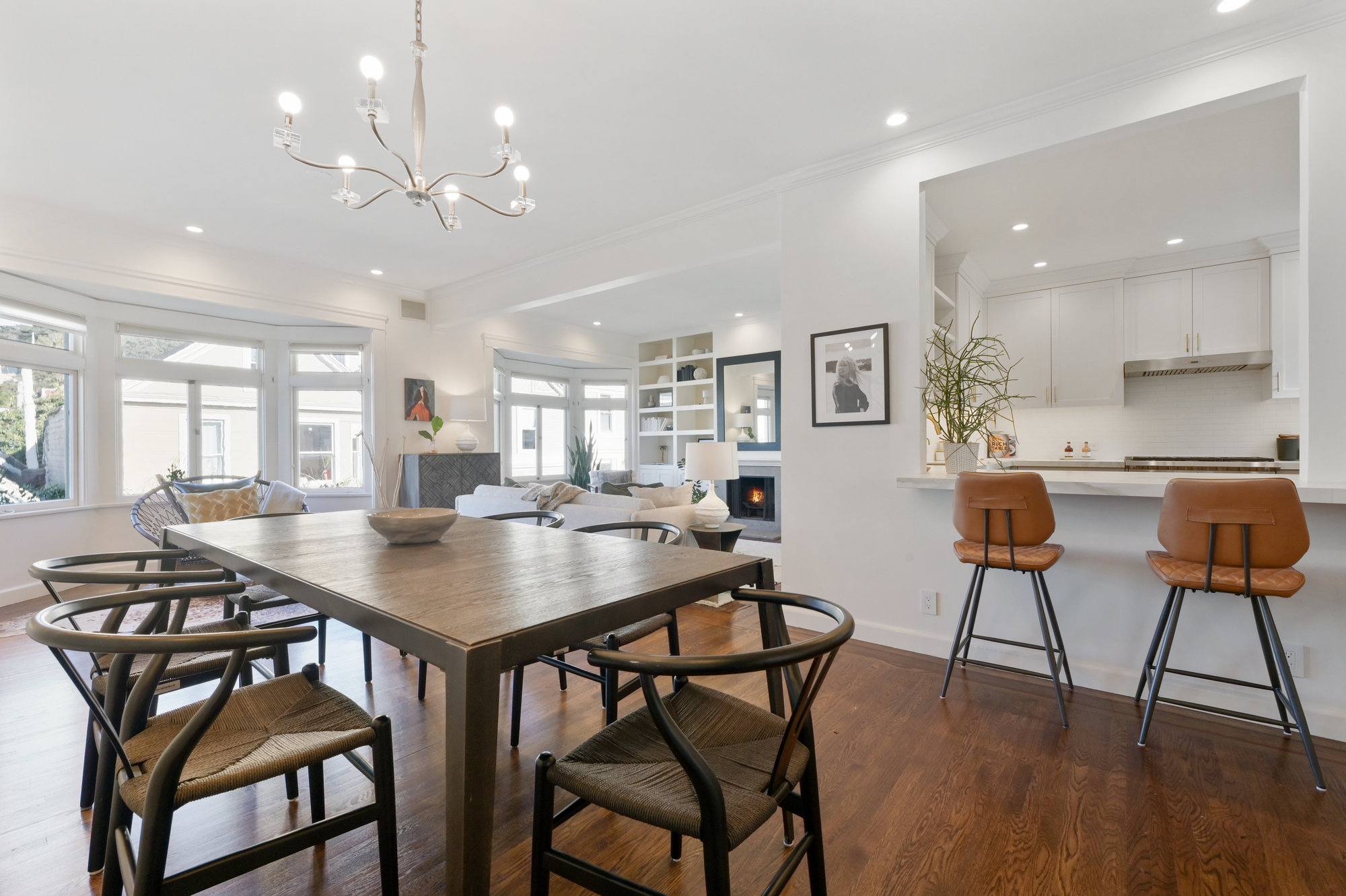 Open floorplan living area, featuring wood floors and large windows