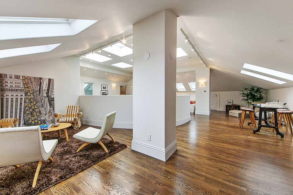 Property Photo: Open floor plan view of several rooms with skylights 