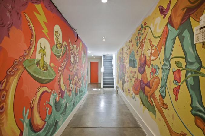 Property Thumbnail: View of the hall leading to 45-49 Belcher Street, featuring walls with colorful painted art-work