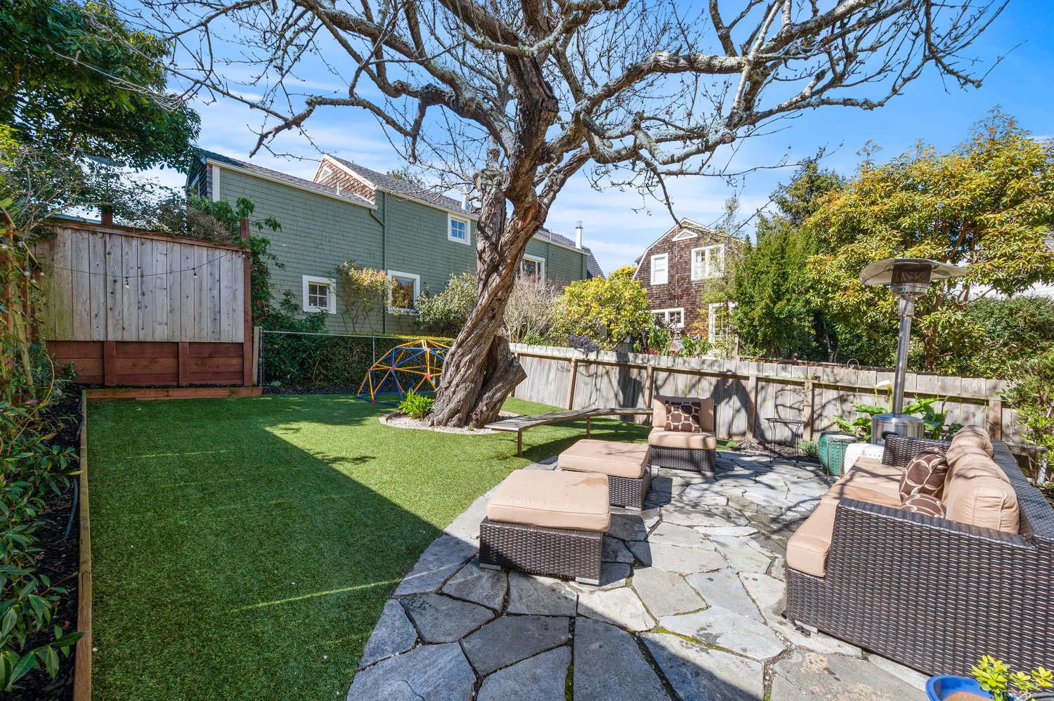 Property Photo: View of the shared yard, featuring a stone patio