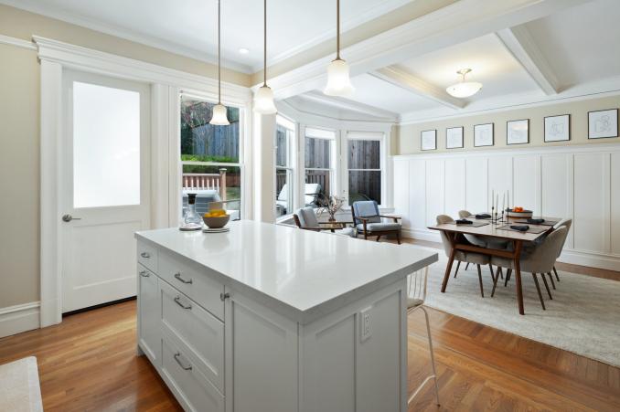 Property Thumbnail: Looking over island in the kitchen in dining room in lower unit. 