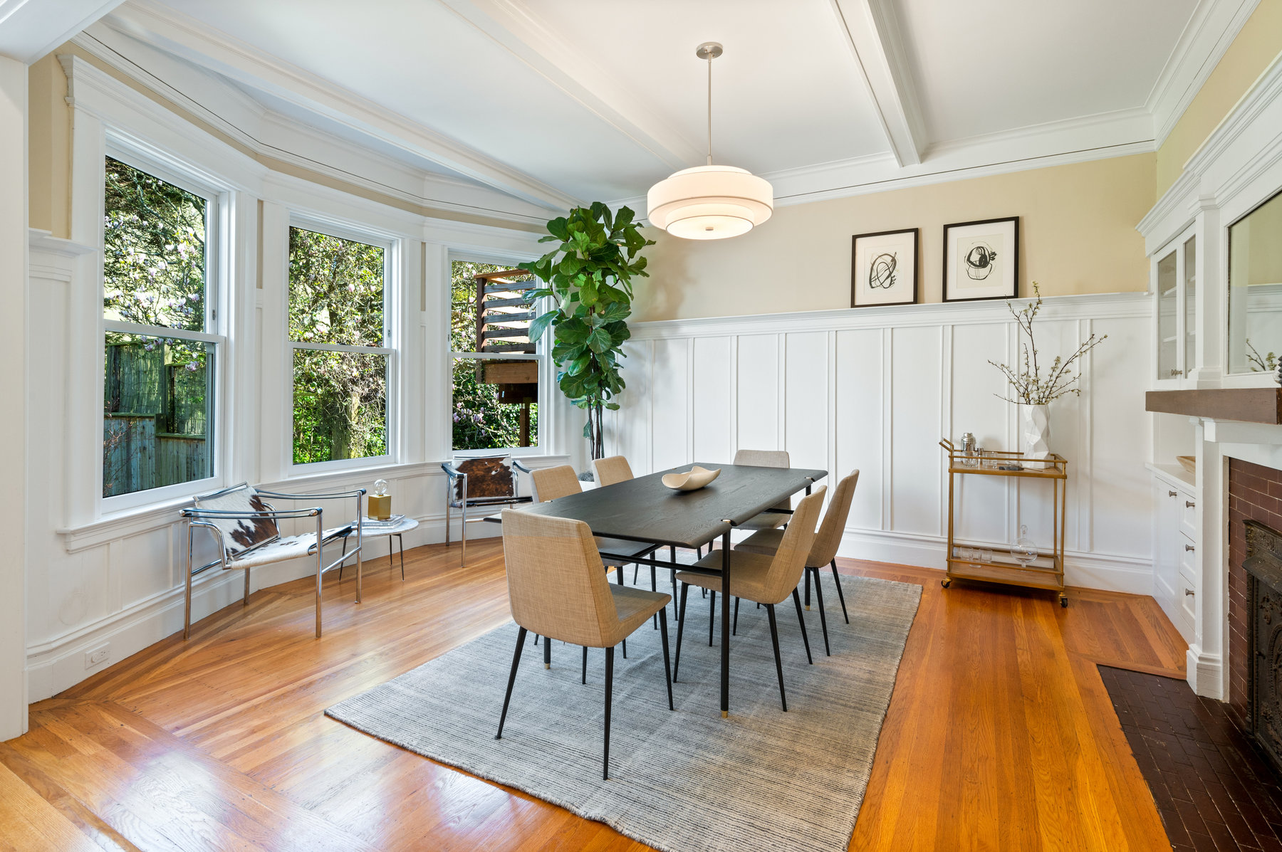 Property Photo: Dining room. Beautiful wood detailing, bay windows looking out to backyard. 