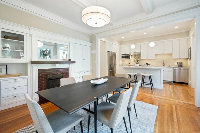 Property Thumbnail: Large dining table that seats six. There is a fireplace with built in cabinets on each side.