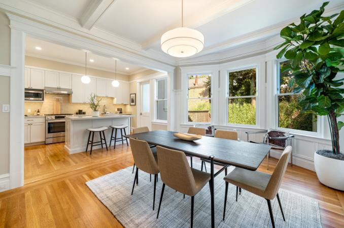Property Thumbnail: Dining area on upper unit that opens up to kitchen. Large bay windows that look out to the back yard.