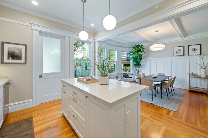 Property Thumbnail: Looking over kitchen island into dining room. Lots of natural light and vaulted ceilings with stunning molding detail. 