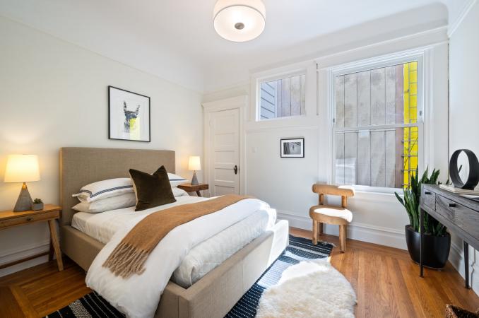 Property Thumbnail: Primary bed has queen bed with tables on each side. Nice large window that lets in lots of natural light. 