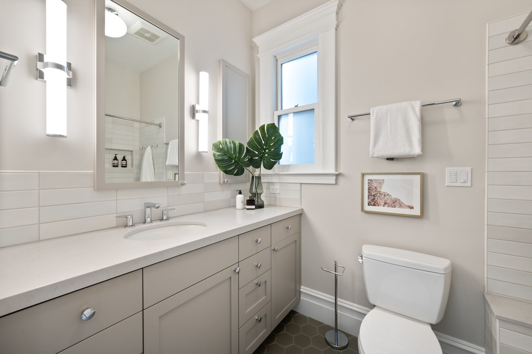 Property Photo: Bathroom with large vanity w/ one sink. Lots of light tones. 