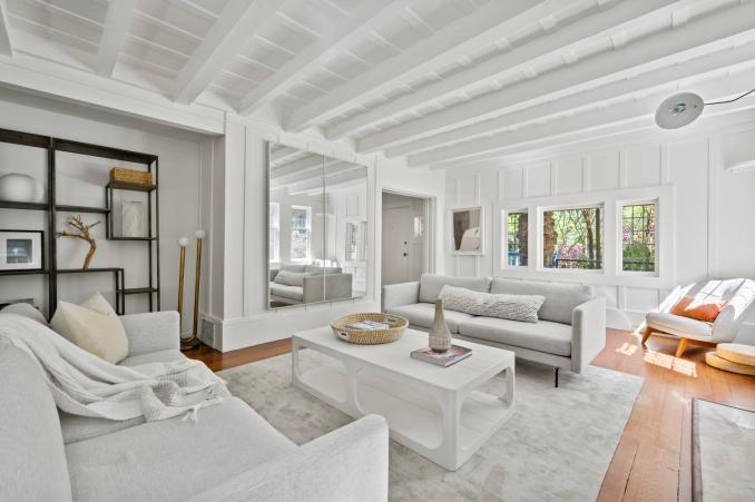 Property Thumbnail: Another photo of living room showing scale of room. Very large space that has built in area with bookshelf.