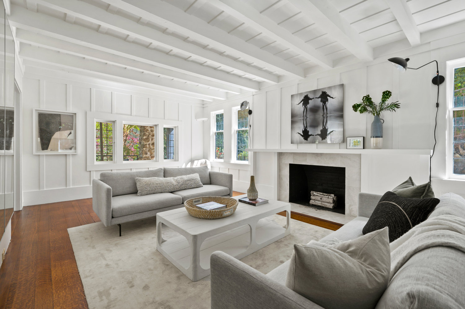 Property Photo: Living room had wood beam detail on ceiling and hardwood floors through out. 