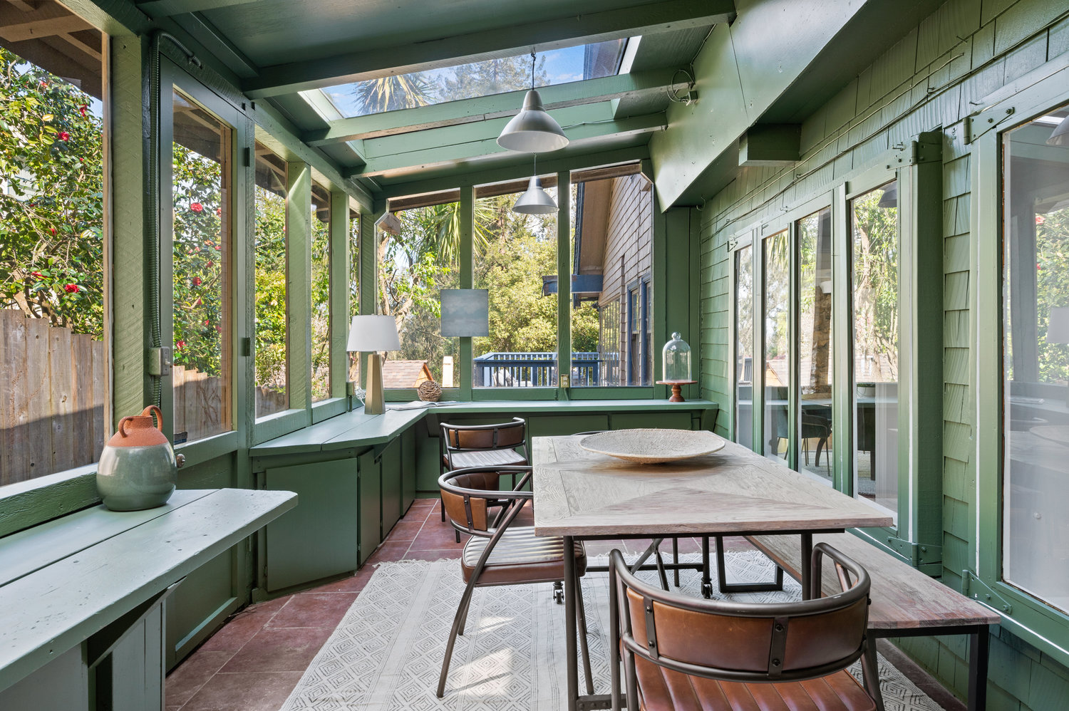 Property Photo: Green room off of kitchen. Nice large table with lots of built it cabinets and lots of windows. 