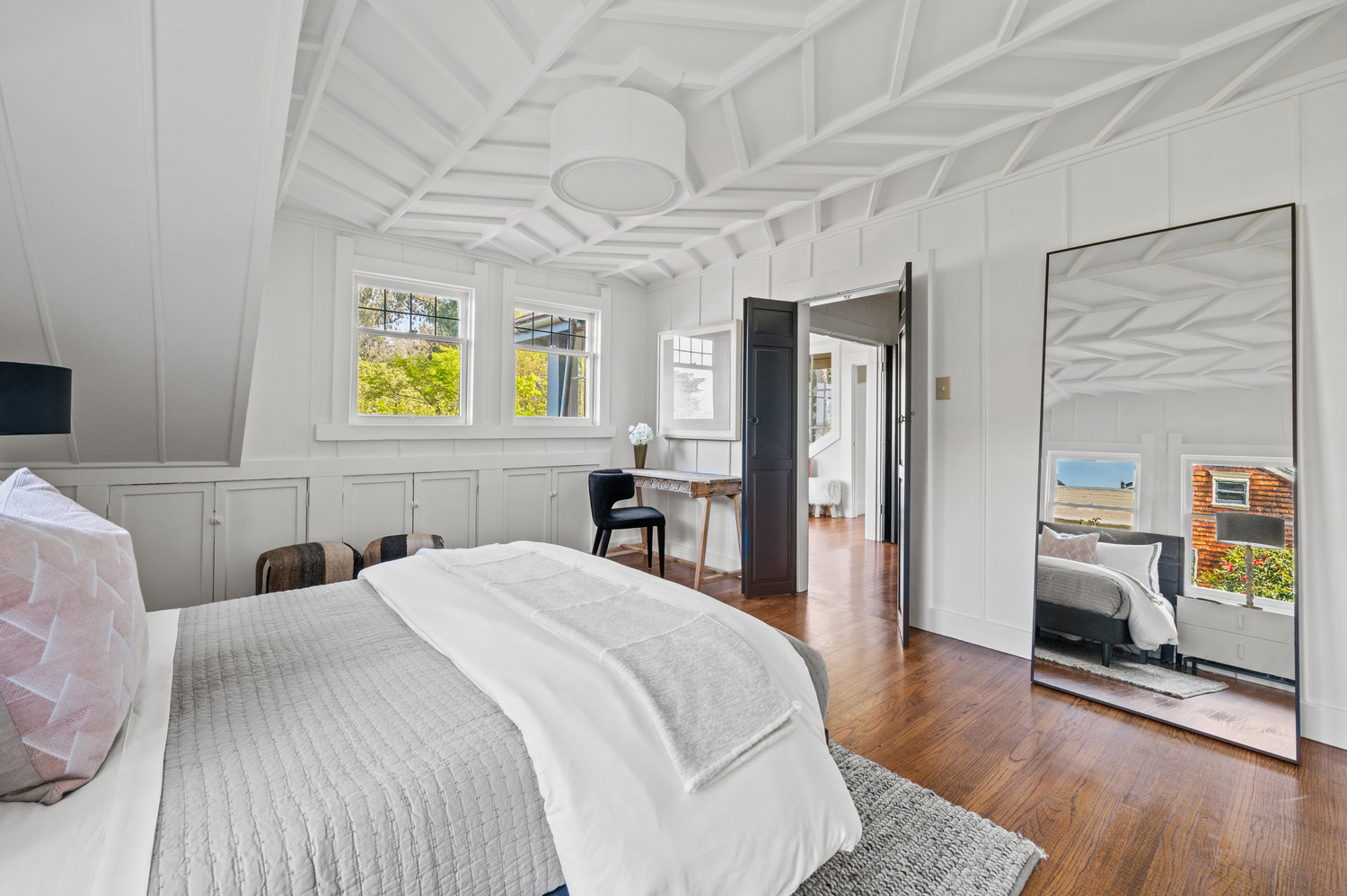 Property Photo: Another view of the guest room. Hardwood floors through out, and built int storage cabinets under windows. 