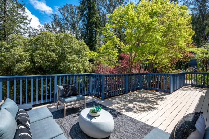 Property Thumbnail: Looking out at all the greenery from deck. Lots of trees. 