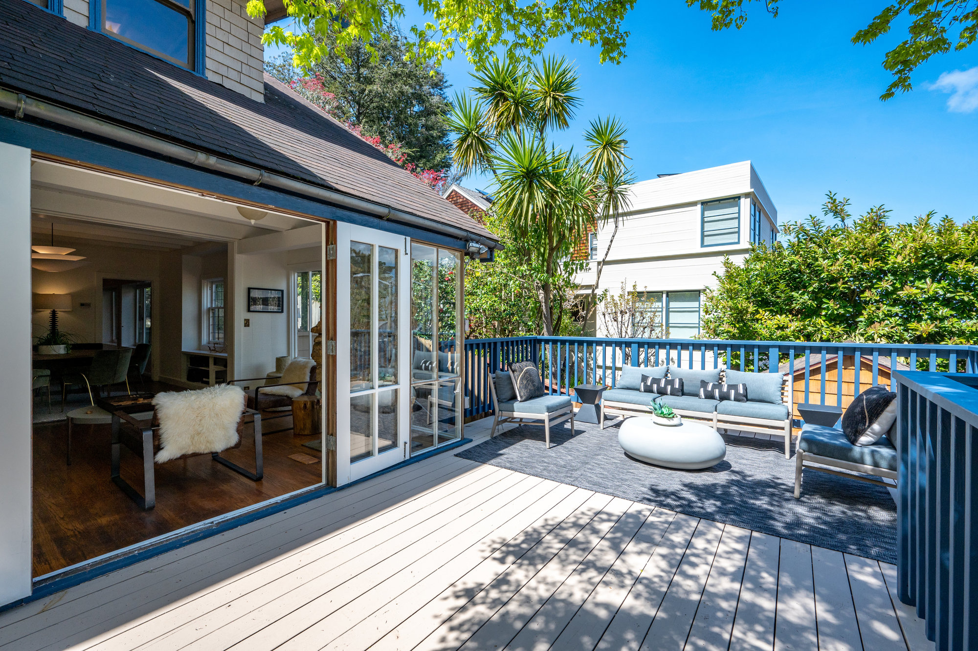 Property Photo: Photo of deck area with french doors that are open and lead into living/dining space. 