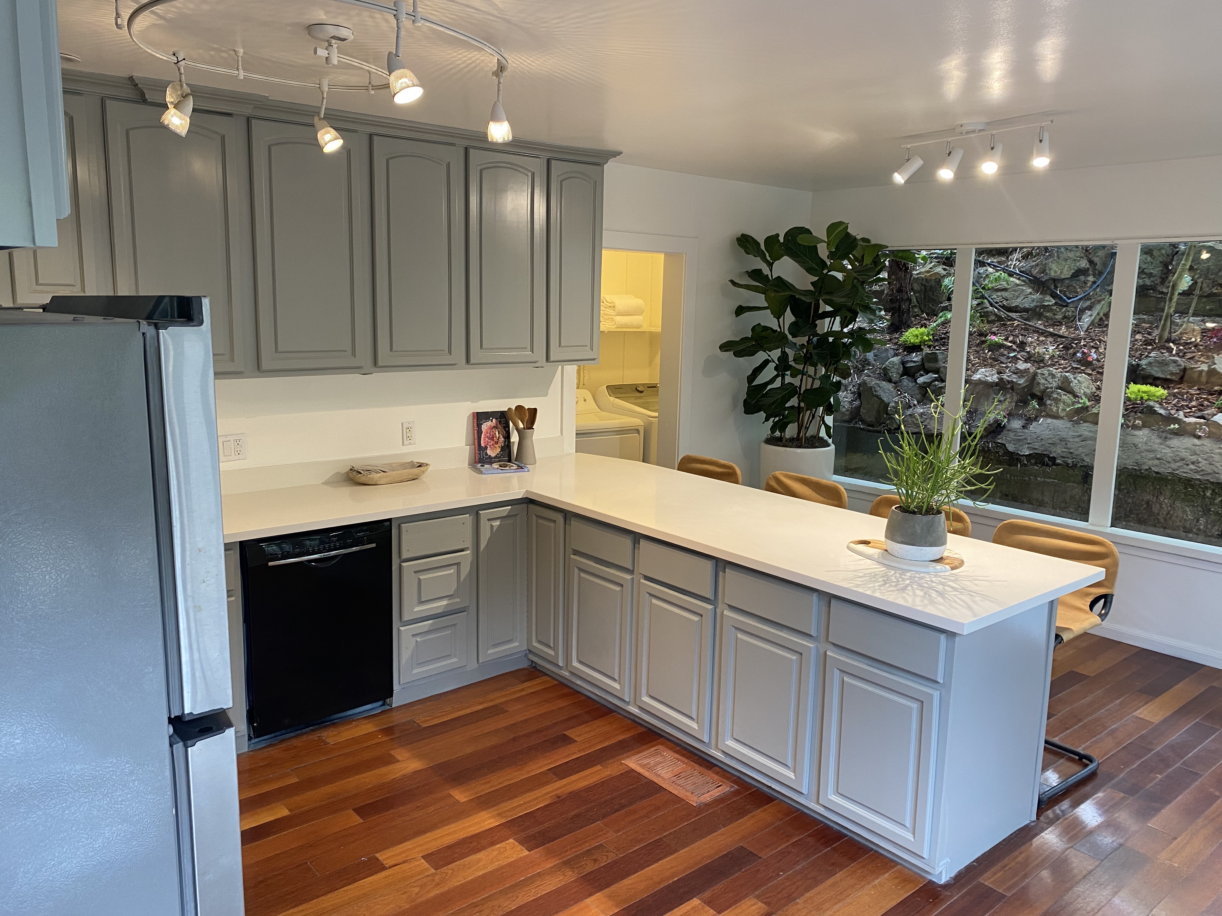 Property Photo: Kitchen has large windows that look out to the hill behind home. 