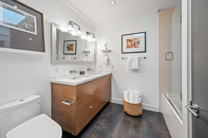 Property Thumbnail: Bathroom has double vanity with white countertops and large tub/shower combo. 