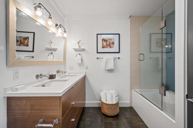 Property Thumbnail: There is a large mirror above double vanity and shower/bath has large glass door. 