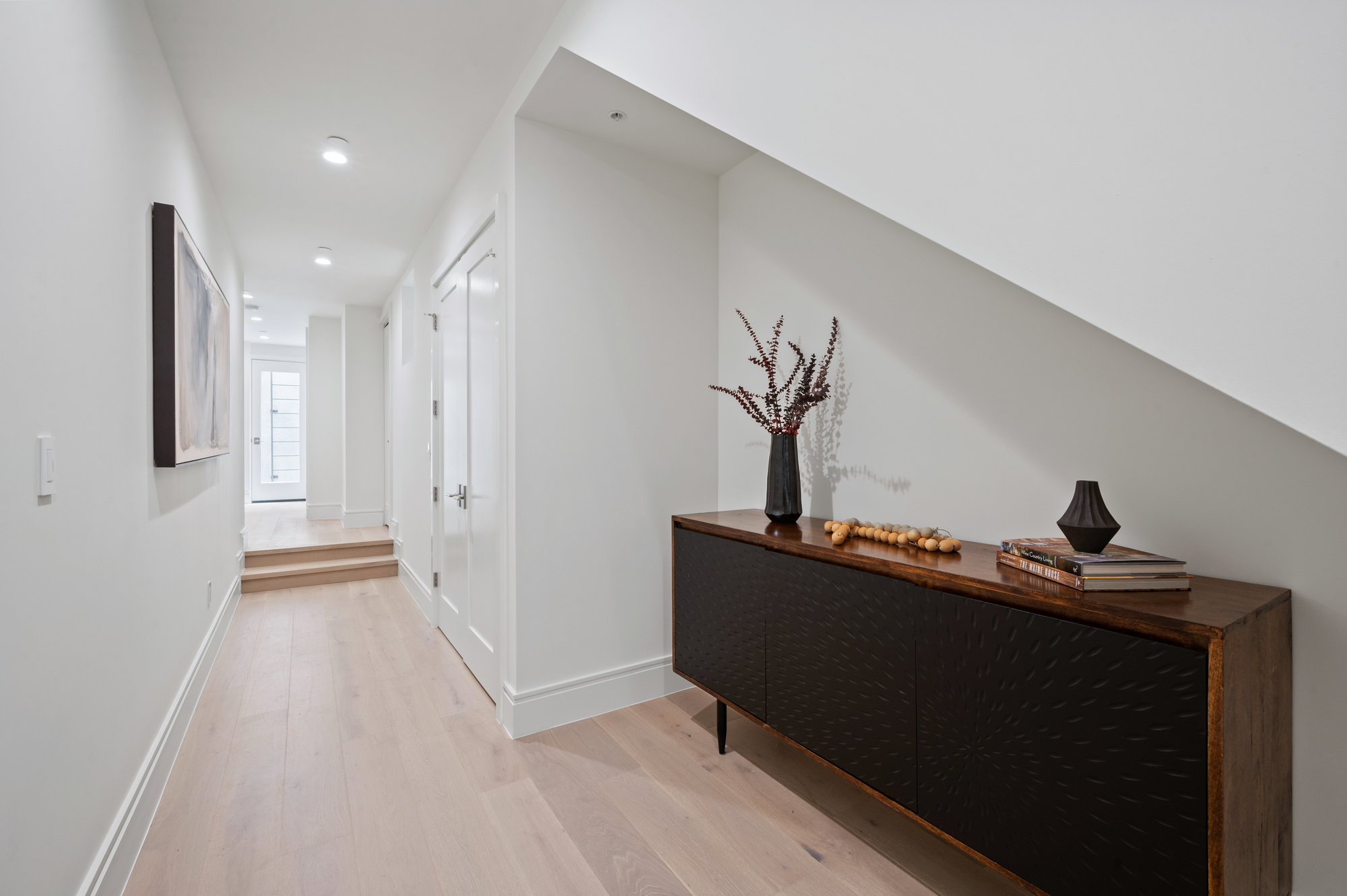 Property Photo: Entery from garage on lower level. You are looking down the hall to the left. There are two steps up before reaching rooms. 