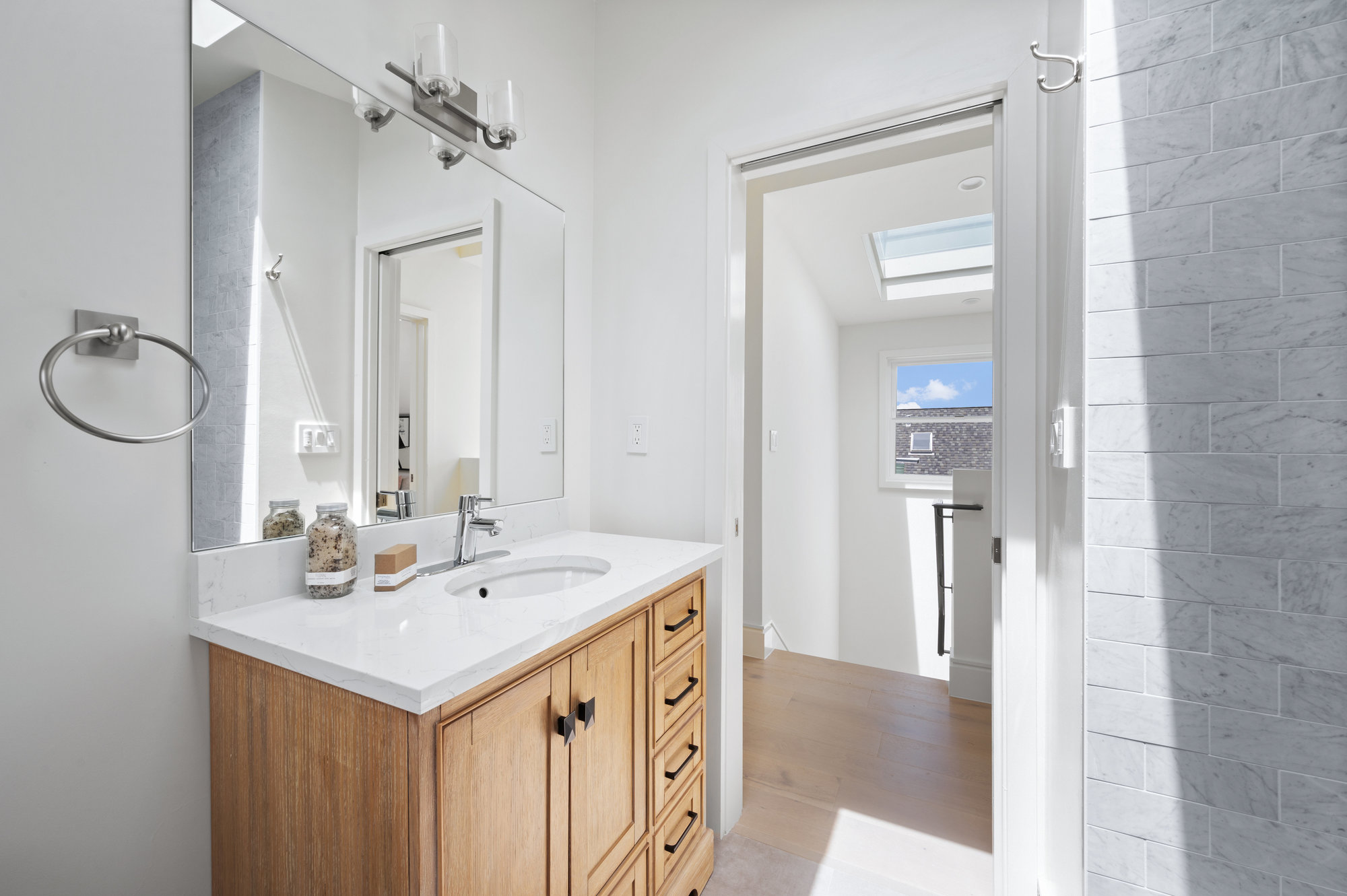 Property Photo: Looking out of the bathroom to stairway on upper level. 