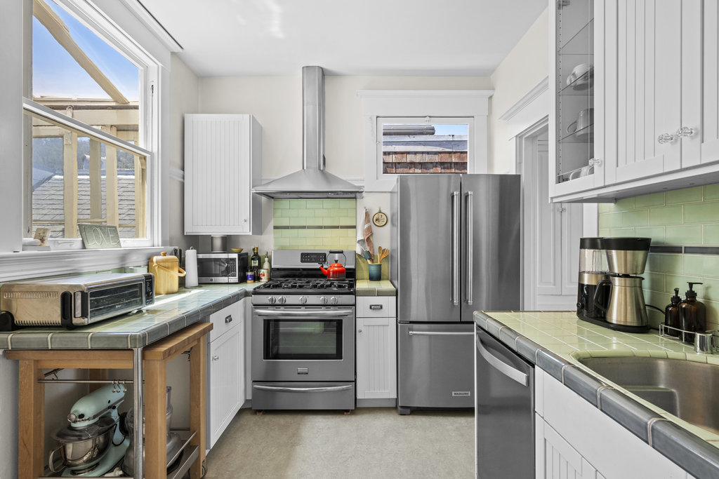 Property Photo: Kitchen has updated stainless steel appliances, with beautiful tile backsplashes and countertops. 