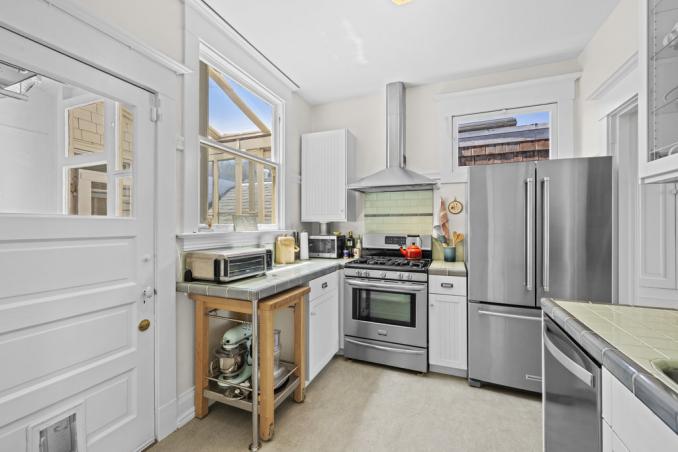 Property Thumbnail: The kitchen has large window that lets in lots of natural light. There is door to the right the leads to laundry room. 