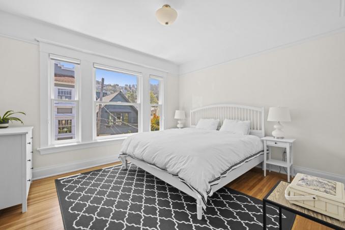Property Thumbnail: Primary bedroom has hardwood floors and large windows that look out onto Alma St. 