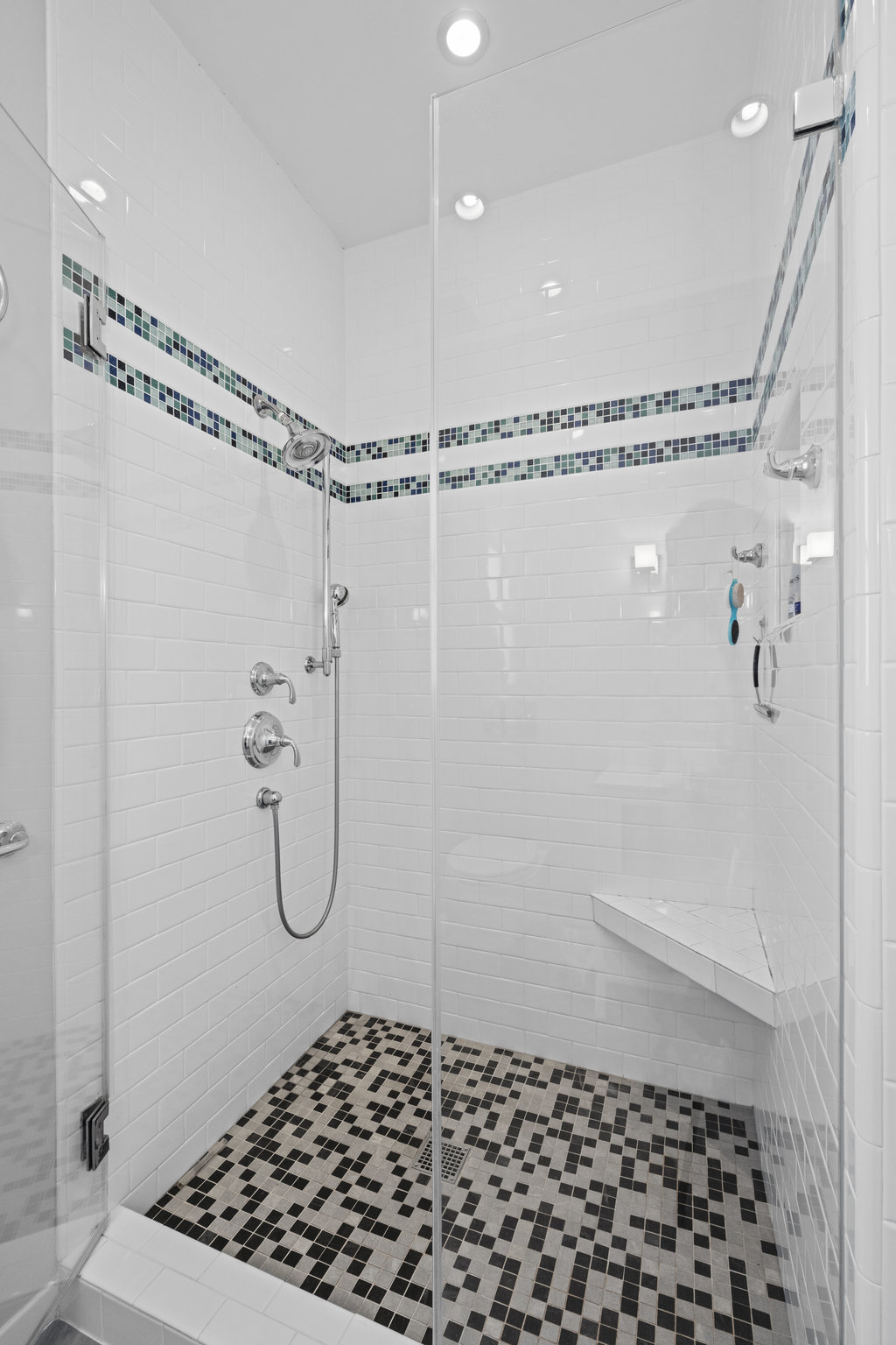 Property Photo: Photo of the shower in primary bathroom. It is all tile with glass door. 