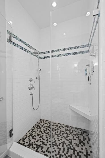 Property Thumbnail: Photo of the shower in primary bathroom. It is all tile with glass door. 