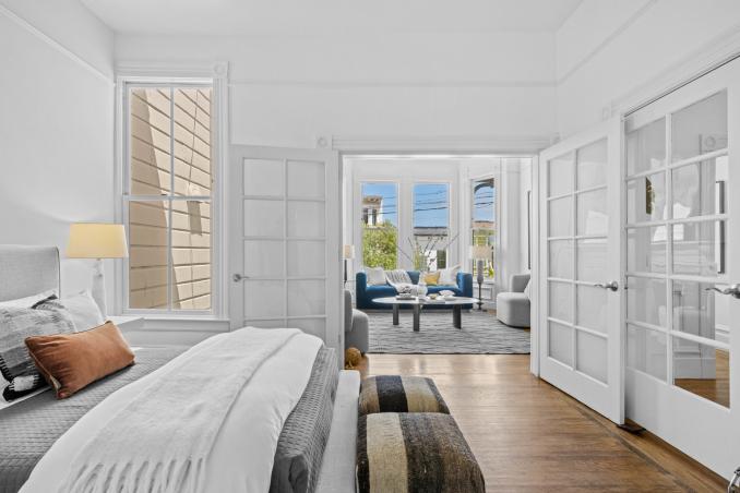 Property Thumbnail: Looking over bedroom to french doors that lead out to living room. 