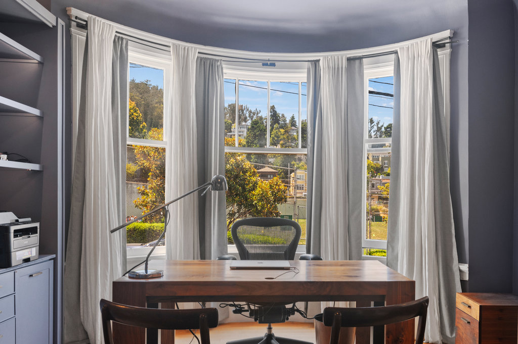 Property Photo: Bay windows in the office look out to the park across the street. 