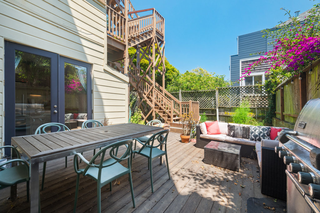 Property Photo: Back deck area has nice large table, sitting area and grill. 