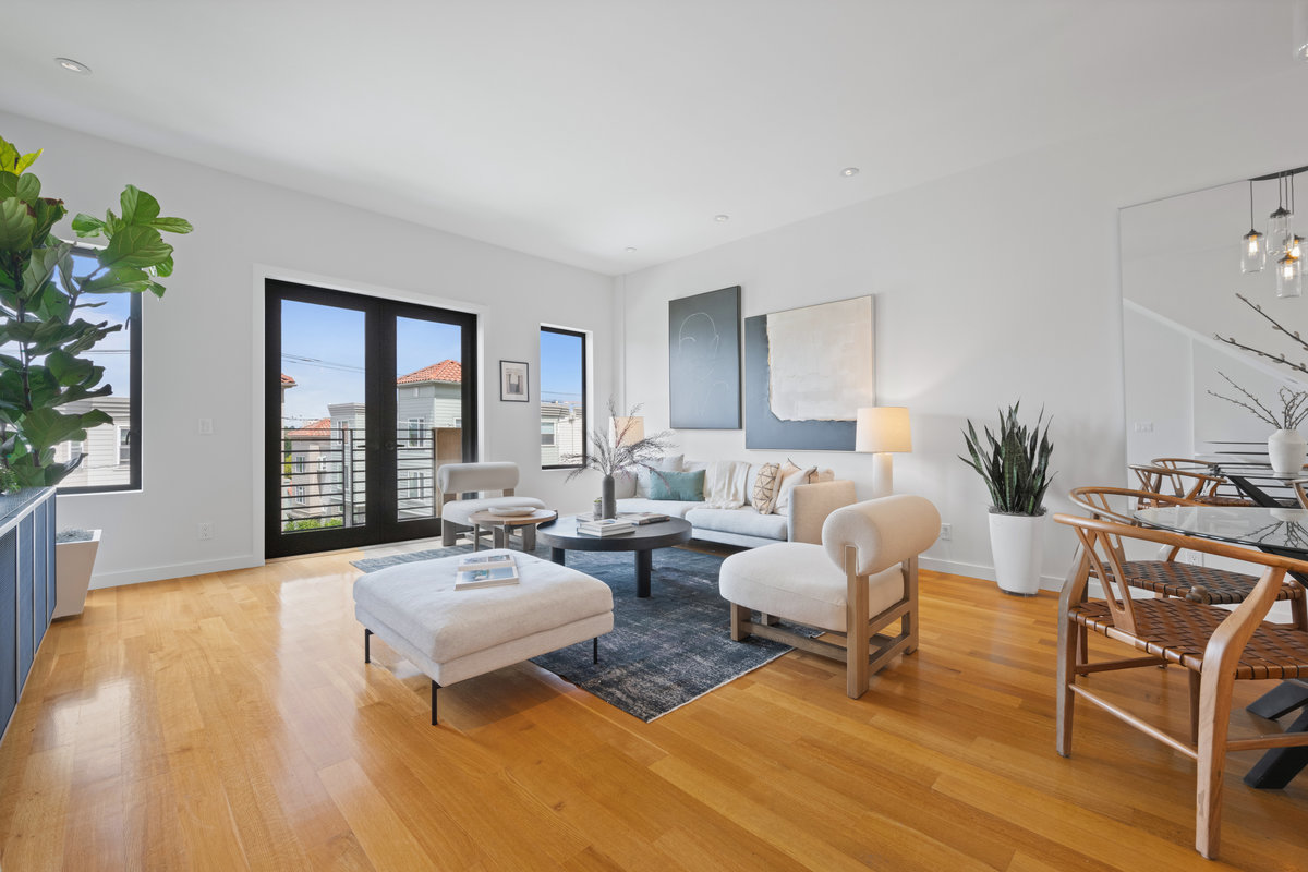 Property Photo: Living room has hardwood floor throughout with small juliet balcony that looks out to Carl Street. 