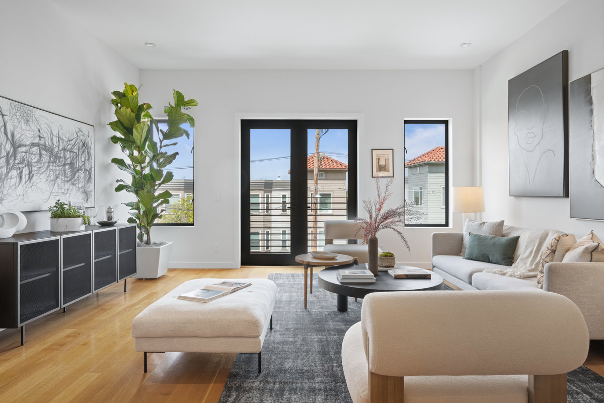 Property Photo: Oversized couch, chairs and ottoman decorate living room. 