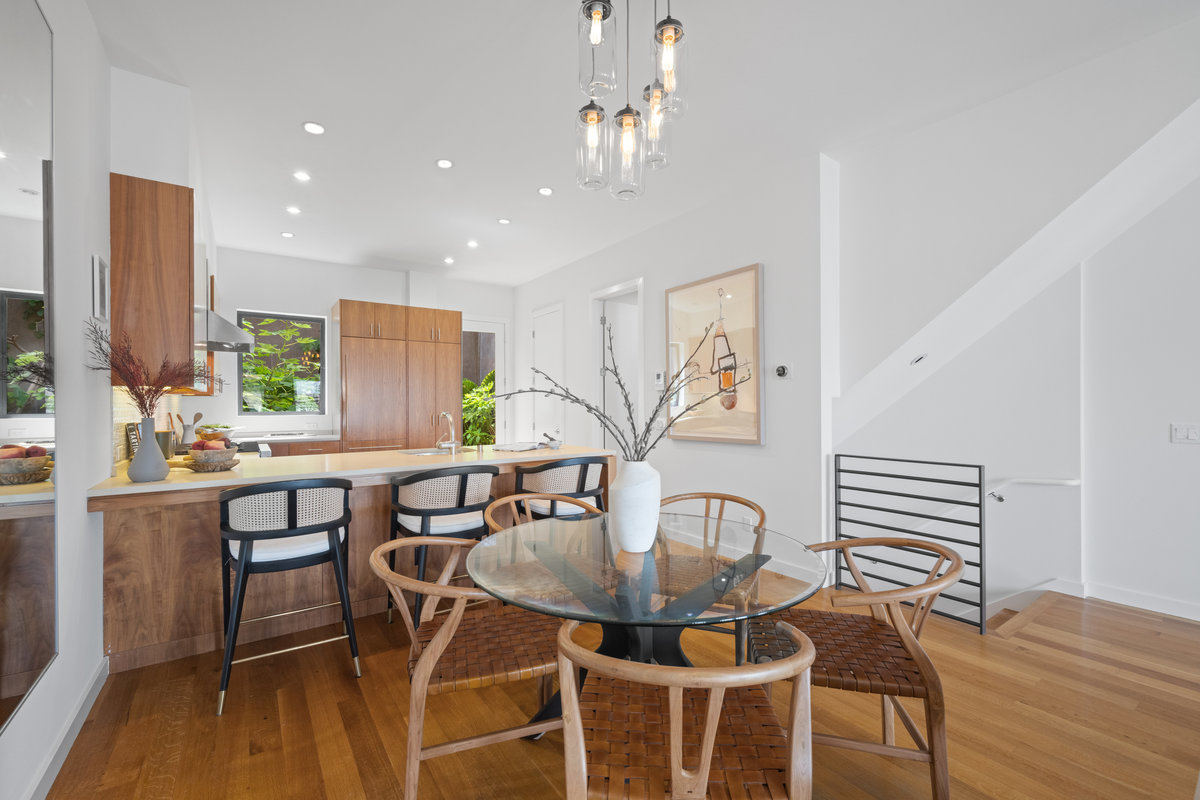 Property Photo: Dining space has a round dining table with 4 chairs. There is additional seating at kitchen counter. 