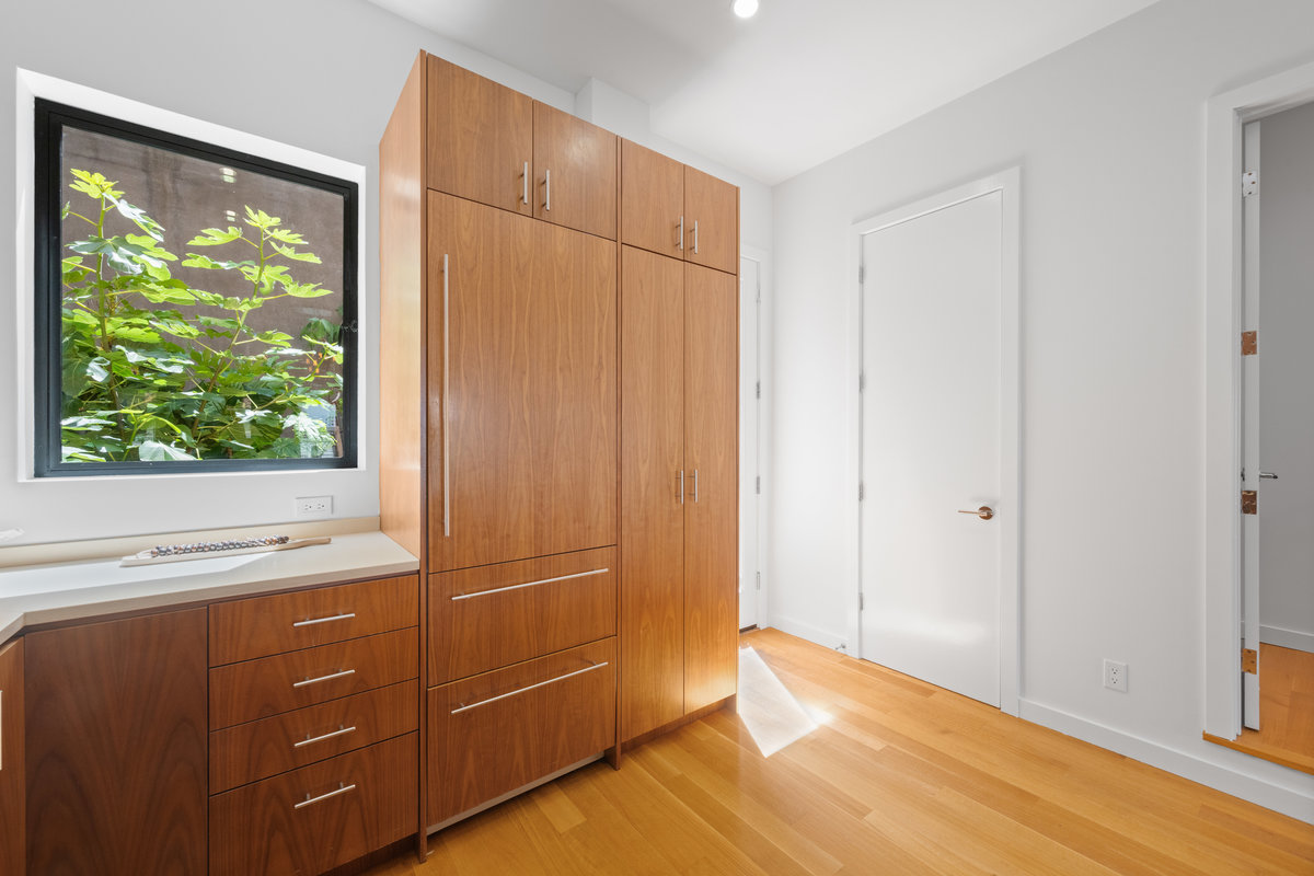 Property Photo: There is large window that looks out to the lush greenery on the back patio.